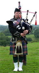 Marie playing bagpipes in Normandy